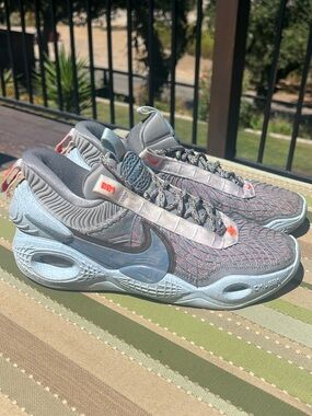 Nike Cosmic Unity Grey Sneakers with Light Blue Soles and Orange Accents